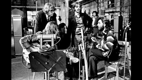 Lennon, McCartney (seated) and Starr (centre) rehearse at the Twickenham studios in 1969, as the band’s assistant Mal Evans and Yoko Ono look on. (Image courtesy Walt Disney Studios) Lennon, McCartney (seated) and Starr (centre) rehearse at the Twickenham studios in 1969, as the band’s assistant Mal Evans and Yoko Ono look on. (Image courtesy Walt Disney Studios)