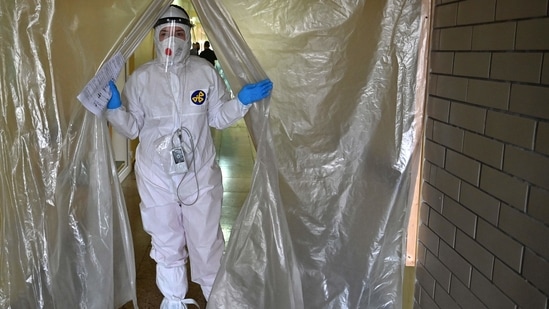 A medical staff wearing personal protective equipment leaves the intensive care unit in one of the hospitals.(AFP)