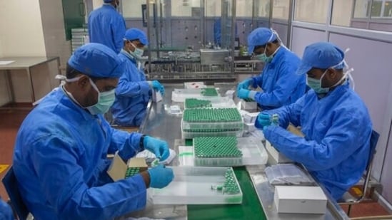 Employees pack boxes containing vials of Covishield, a version of the AstraZeneca vaccine, at the Serum Institute of India in Pune.(AP)