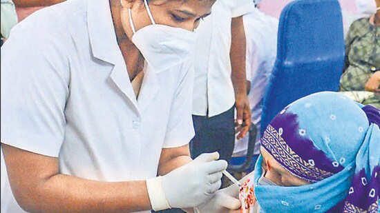A beneficiary receive a dose of Covid-19 vaccine at a vaccination centre in Thane on Friday. (PTI)