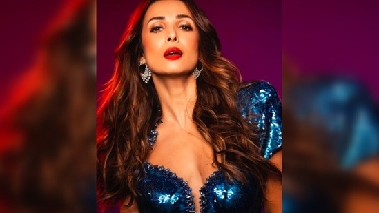 With bold red lips and blushed cheeks, Malaika Arora looked to-die-for with her wavy hair left open.(Instagram/@malaikaaroraofficial)