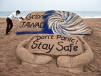 Puri artist Sudarshan Pattanaik gives finishing touches to a sand sculpture to create awareness on cyclone Jawad. (PTI) Puri artist Sudarshan Pattanaik gives finishing touches to a sand sculpture to create awareness on cyclone Jawad. (PTI)