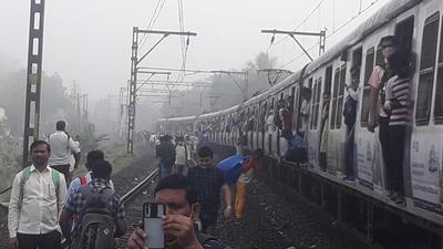 Bunching of local trains on slow and fast tracks resulted in commuters choosing to walk along the tracks during the morning peak hour. (HT Photo) Bunching of local trains on slow and fast tracks resulted in commuters choosing to walk along the tracks during the morning peak hour. (HT Photo)