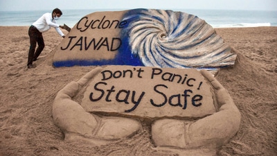 Puri artist Sudarshan Pattanaik gives finishing touches to a sand sculpture to create awareness on Cyclone Jawad. (PTI) Puri artist Sudarshan Pattanaik gives finishing touches to a sand sculpture to create awareness on Cyclone Jawad. (PTI)