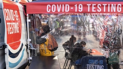 A person takes the Covid-19 test in Times Square on Friday. (AP) A person takes the Covid-19 test in Times Square on Friday. (AP)