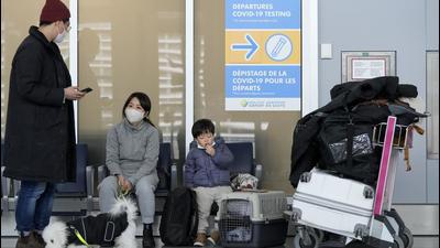 A family waits to travel to the United States of America at Pearson International Airport during the Covid-19 pandemic in Toronto. (AP) A family waits to travel to the United States of America at Pearson International Airport during the Covid-19 pandemic in Toronto. (AP)