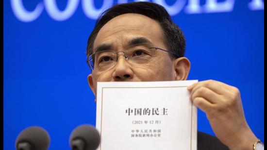 Xu Lin, vice minister of the Publicity Department of the Central Committee of China's Communist Party holds a copy of a government-produced report titled Democracy that Works during a press conference at the State Council Information Office in Beijing, on Saturday. (AP) Xu Lin, vice minister of the Publicity Department of the Central Committee of China's Communist Party holds a copy of a government-produced report titled Democracy that Works during a press conference at the State Council Information Office in Beijing, on Saturday. (AP)