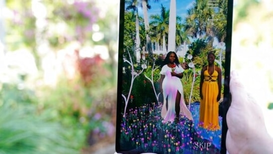 The late Breonna Taylor, left, and her sister Ju'Niyah Palmer, right, are shown on a screen as part of an augmented reality (AR) garden titled "Breonna's Garden" made in her honour at the Maurice A. Ferre Park next to the Perez Art Museum during Miami Art Week in Miami. Palmer collaborated on the project with artist Lady PheOnix&nbsp;(AP Photo/Lynne Sladky)