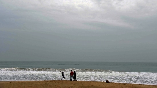 People visit the deserted Chandrabhaga sea beach, amid Cyclone Jawad threat in Puri on Saturday, December 4. Fishermen have been advised not to venture into west central and northwest Bay of Bengal and along and off north Andhra Pradesh-Odisha-West Bengal coasts during December 4 and 5.(PTI)