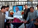 Businessmen put candles and rose petals next to the portrait of a Sri Lankan manager of a sports equipment factory, as they pay tribute to him outside the office of Sialkot Chamber of Commerce and Industry in Sialkot, Pakistan