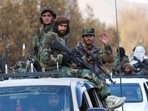 Members of Taliban sit on a military vehicle during Taliban military parade in Kabul, Afghanistan.