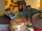 This man tries his best to read a book while his pet dog and cat keep distracting him. (reddit/@iamtheliquor__)