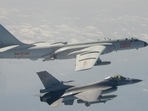 A Taiwanese F-16 fighter jet flying next to a Chinese H-6 bomber (top) off the coast of Taiwan. A Taiwanese F-16 fighter jet flying next to a Chinese H-6 bomber (top) off the coast of Taiwan.