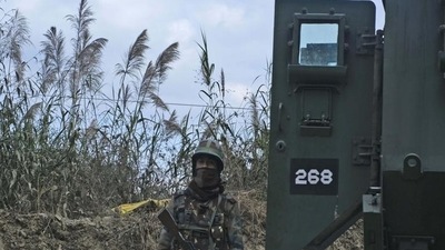 An Army personnel stands guard on a highway on the outskirts of Kohima on Sunday, (AP) An Army personnel stands guard on a highway on the outskirts of Kohima on Sunday, (AP)