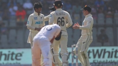 New Zealand's Rachin Ravindra, left, celebrates the dismissal of India's Virat Kohli with his team players during the day three of their second test cricket match with India in Mumbai, India, Sunday, Dec. 5, 2021.(AP Photo/Rafiq Maqbool) (AP) New Zealand's Rachin Ravindra, left, celebrates the dismissal of India's Virat Kohli with his team players during the day three of their second test cricket match with India in Mumbai, India, Sunday, Dec. 5, 2021.(AP Photo/Rafiq Maqbool) (AP)
