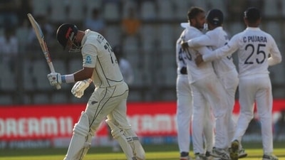 New Zealand's Daryl Mitchell ,left, walks back after his dismissal during the day three of their second test cricket match with India in Mumbai, India, Sunday, Dec. 5, 2021.(AP Photo/Rafiq Maqbool) (AP) New Zealand's Daryl Mitchell ,left, walks back after his dismissal during the day three of their second test cricket match with India in Mumbai, India, Sunday, Dec. 5, 2021.(AP Photo/Rafiq Maqbool) (AP)