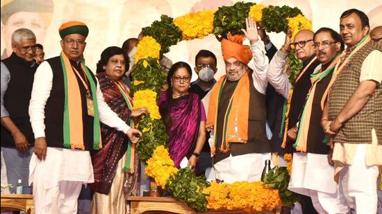 Union home minister Amit Shah and former Rajasthan chief minister BJP national vice-president Vasundhara Raje being garlanded at 'Janpratinidhi Sankalp Sammelan', in Jaipur on Sunday. (ANI)