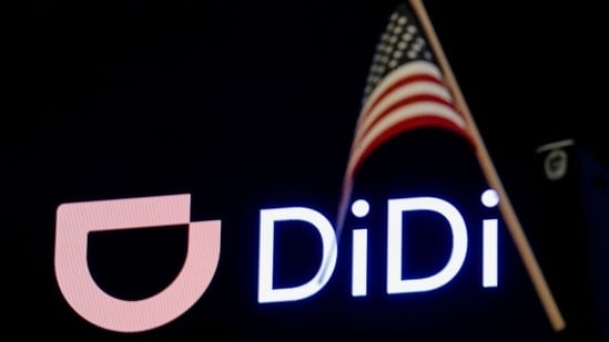 An American flag is pictured in front of the logo for Chinese ride hailing company Didi Global Inc. during the IPO on the New York Stock Exchange (NYSE) floor in New York City, US.(REUTERS)