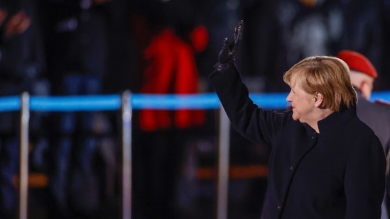 German Chancellor Angela Merkel waves goodbye at the Defence Ministry during the Grand Tattoo (Grosser Zapfenstreich), a ceremonial send-off for her in Berlin.(AP)