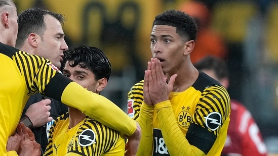 Dortmund's Jude Bellingham, right, watches referee Felix Zwayer during the German Bundesliga soccer match between Borussia Dortmund and Bayern Munich in Dortmund, Germany.(AP)