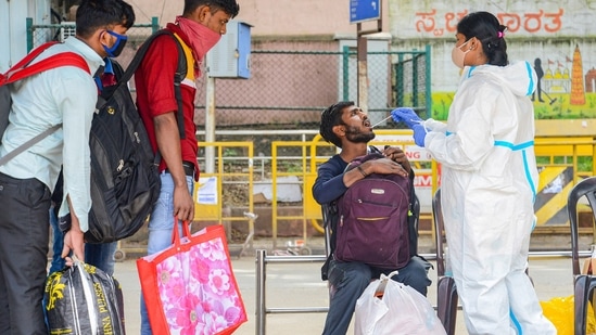 A health worker collecting swab samples at KSR railway station in Bengaluru,(PTI)