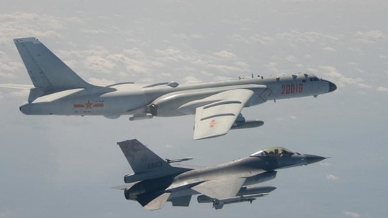 A Taiwanese F-16 fighter jet flying next to a Chinese H-6 bomber (top) off the coast of Taiwan.(AFP / File)
