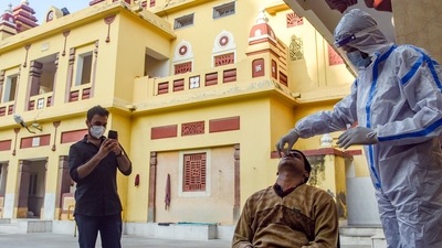 A healthcare worker collects a swab sample of a man for the Covid-19 test at Birla Mandir amid the threat of new Covid-19 variant Omicron, in New Delhi. (HT Photo) A healthcare worker collects a swab sample of a man for the Covid-19 test at Birla Mandir amid the threat of new Covid-19 variant Omicron, in New Delhi. (HT Photo)