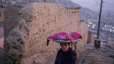 An Afghan boy carries a tray of bread on his head, in Kabul, Afghanistan. (AP) An Afghan boy carries a tray of bread on his head, in Kabul, Afghanistan. (AP)
