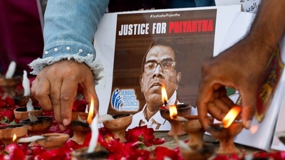 People light oil lamps next to laid roses to express their condolences to the people of Sri Lanka, following the lynching of the Sri Lankan manager. (REUTERS)