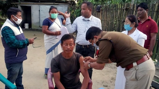 Sonitpur Superintendent of Police Dhananjay Ghanwat injects a dose of Covid-19 vaccine to a beneficiary as part of the 'Har Ghar Dastak' vaccination campaign, on Saturday.(ANI Photo) Sonitpur Superintendent of Police Dhananjay Ghanwat injects a dose of Covid-19 vaccine to a beneficiary as part of the 'Har Ghar Dastak' vaccination campaign, on Saturday.(ANI Photo)