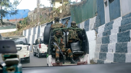 Indian army soldiers ride past the main town in a convoy in Kohima, capital of northeastern Nagaland state, India, Sunday.(AP)