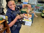The image shows the officer holding the rescued snake. (Facebook/@Clearwater Police Department) The image shows the officer holding the rescued snake. (Facebook/@Clearwater Police Department)