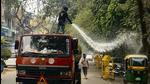 A municipal worker sprays water on roadside trees as part of efforts to reduce air pollution in New Delhi. (AP/File) A municipal worker sprays water on roadside trees as part of efforts to reduce air pollution in New Delhi. (AP/File)
