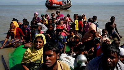 Rohingya refugees sit on a makeshift boat as they get interrogated by the Border Guard Bangladesh after crossing the Bangladesh-Myanmar border, at Shah Porir Dwip near Cox's Bazar (REUTERS) Rohingya refugees sit on a makeshift boat as they get interrogated by the Border Guard Bangladesh after crossing the Bangladesh-Myanmar border, at Shah Porir Dwip near Cox's Bazar (REUTERS)
