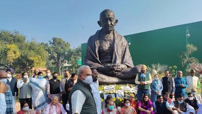 &nbsp;Opposition MPs protest in front of the Mahatma Gandhi statue at the Parliament premises over the suspension of 12 Rajya Sabha MPs. (ANI Photo)
