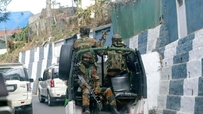Soldiers ride past the main town in a convoy in Nagaland capital Kohima. (AP) Soldiers ride past the main town in a convoy in Nagaland capital Kohima. (AP)
