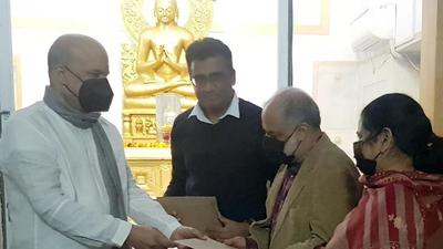 Sri Lankan high commissioner Milinda Moragoda, who proposed sending the mission’s long-serving staffers on an island tour, handed over the travel documents ahead of their visit at Maha Bodhi temple in New Delhi. (Photo courtesy: Sri Lankan high commission)