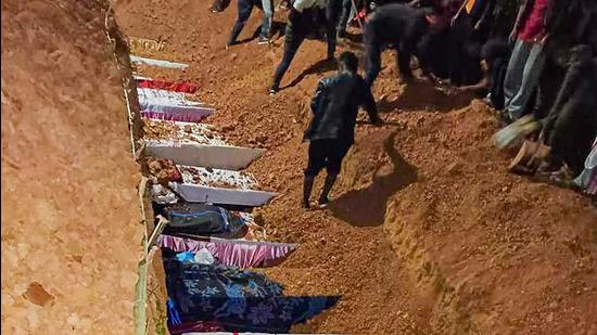Coffins of the 13 people, who were allegedly killed by Armed Forces, buried during their funeral in Mon district on Monday. (PTI)