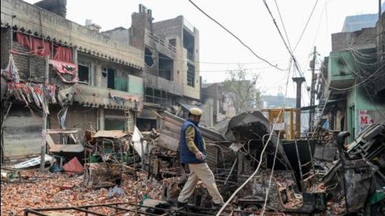 In this file photo taken in 2020, a security personnel patrols near burnt-out and damaged residential premises and shops following clashes between people supporting and opposing a contentious amendment to India's citizenship law, in New Delhi. (AFP)