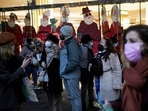 Pedestrians wear masks to prevent the spread of the Covid-19 as they walk past a store decorated as part of Christmas lightings in Paris, on Monday, December 6, 2021. (AP) Pedestrians wear masks to prevent the spread of the Covid-19 as they walk past a store decorated as part of Christmas lightings in Paris, on Monday, December 6, 2021. (AP)