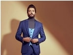 Riteish Deshmukh, in a blue checkered suit, is making it worth the stare