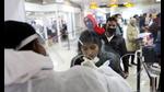 A healthcare worker collects a coronavirus disease (COVID-19) test swab sample from a woman at the Indira Gandhi International Airport in New Delhi. (Reuters)