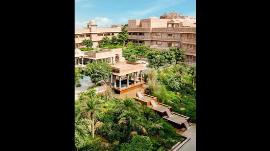 The central courtyard features a cascading water feature and lush indigenous planting