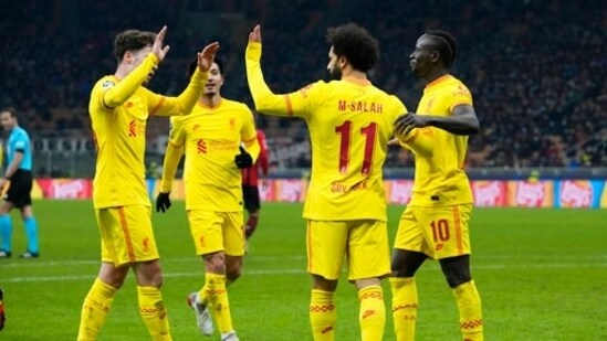 Liverpool's Mohamed Salah, center, celebrates with teammates after scoring his side's first goal during the Champions League, Group B soccer match between AC Milan and Liverpool at the San Siro stadium in Milan.(AP)