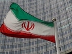An Iranian flag flutters in front of the International Atomic Energy Agency (IAEA) headquarters in Vienna, Austria.