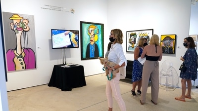 People look at contemporary art by artist Andres Valencia, 10, displayed by Chase Contemporary at Art Miami during Miami Art Week. Proceeds from Valencia's work go to the Perry J. Cohen foundation, which supports the arts, and environmental and wildlife education and preservation. (AP Photo/Lynne Sladky) People look at contemporary art by artist Andres Valencia, 10, displayed by Chase Contemporary at Art Miami during Miami Art Week. Proceeds from Valencia's work go to the Perry J. Cohen foundation, which supports the arts, and environmental and wildlife education and preservation. (AP Photo/Lynne Sladky)