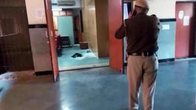 A police person inspects the explosion spot at Rohini court in New Delhi. (ANI) A police person inspects the explosion spot at Rohini court in New Delhi. (ANI)