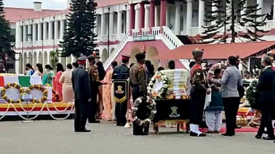 Dignitaries lay a wreath on the mortal remains of Chief of Defence Staff (CDS) General Bipin Rawat, his wife Madhulika Rawat, and other defence personnel, who died in the Coonoor chopper crash at Madras Regimental Centre in Nilgiris on Thursday. (ANI PHOTO.)