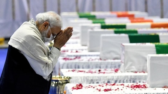 Prime Minister Narendra Modi pays tribute to the mortal remains of Chief of Defence Staff (CDS) General Bipin Rawat, his wife Madhulika Rawat and 11 other Armed Forces personnel who lost their lives in a chopper crash yesterday, at Palam airbase in New Delhi on Thursday. (ANI PHOTO)