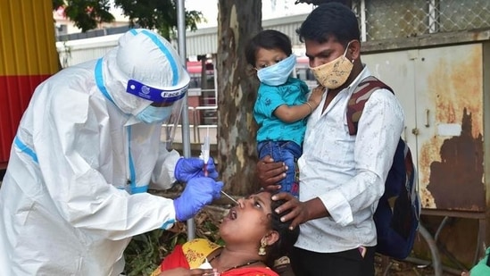 File photo of a health taking swab samples from a woman outside a railway station. File photo of a health taking swab samples from a woman outside a railway station.